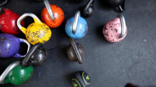 Vibrant multicolor kettlebells for diverse fitness workouts.